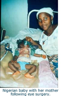 Nigerian baby with her mother following eye surgery.